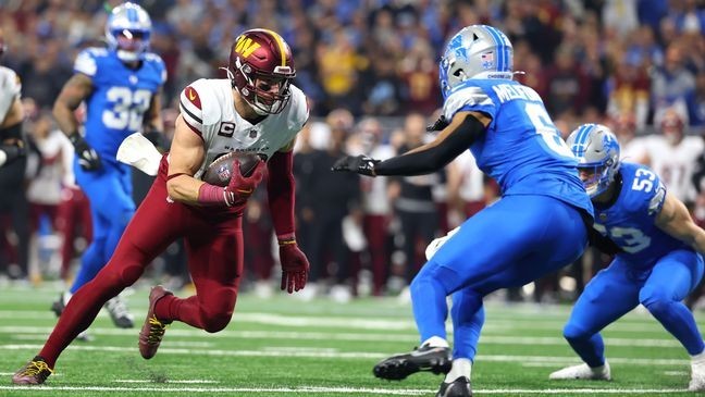 DETROIT, MICHIGAN - JANUARY 18: Zach Ertz #86 of the Washington Commanders catches a pass and runs the ball against Ifeatu Melifonwu #6 of the Detroit Lions during the second quarter in the NFC Divisional Playoff at Ford Field on January 18, 2025 in Detroit, Michigan.  (Photo by Gregory Shamus/Getty Images)